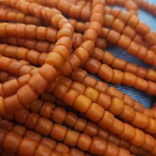 Indonesian Glass "Tube" beads.  approx 4 x 4mm.  24" strand.  Approx 150 Beads/ Strand.  *Opaque Harvest Orange