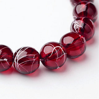 Transparent Glass Beads.  Round.  8mm.  Rustic Red with slight White Splatter.  (approx 50 Beads per 16" Strand)