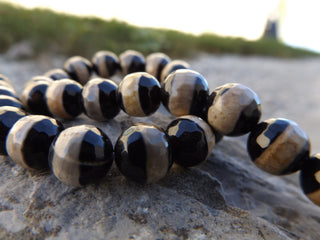Agate *Black with Tan Band.   (Round 10mm) *16 inch strand.  (Faceted) - Mhai O' Mhai Beads
 - 2