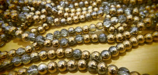 Glass Beads (Half Plated Copper)  5.5 to 6.5mm rounds.  (approx 68 beads per 15" strand)