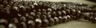 Glass (Faceted) *6mm Round.  Black with a Pearl Luster Plating.  approx 50 beads per strand.