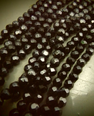 Glass (Faceted) *6mm Round.  Black with a Pearl Luster Plating.  approx 50 beads per strand.