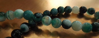 Agate (8mm rounds) 15.5" strand.  approx 50 beads.  Striped Green