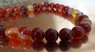 Banded Agate (8mm rounds) 15.5" strand.  approx 43 beads.  Striped Reds