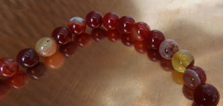 Banded Agate (8mm rounds) 15.5" strand.  approx 43 beads.  Striped Reds