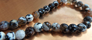 Agate (8mm rounds) 15.5" strand.  *Faceted.  approx 47 beads.  Fire Agate Black/Tan/White