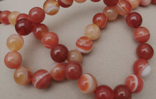 Agate (8mm rounds) 15.5" strand.  approx 43 beads.  Striped  Nat Orange/Rust